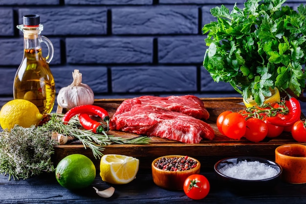 Chuck eye beef steaks on wooden board