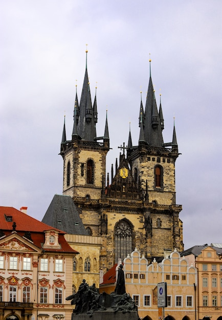 church in Prague with the memorial of Jan Hus below on a cloudy day.