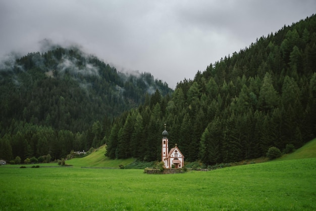 Church of St Johann in Ranui on cloudy overcast day Dolomite Alps Vilnoss Valley South Tyrol Italy