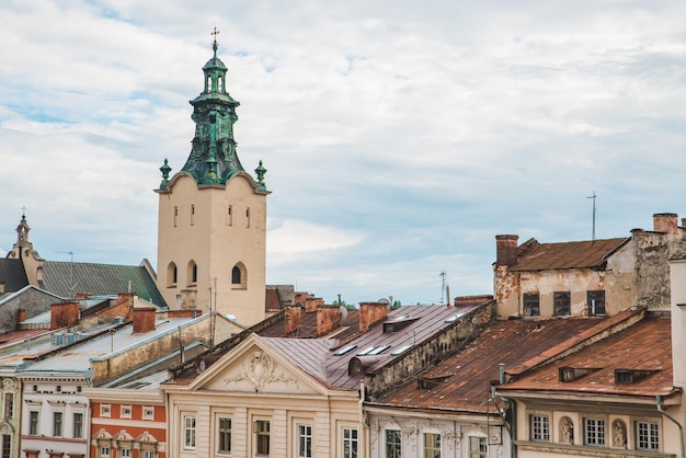 Church tower over old building roofs. overcast weather. copy space