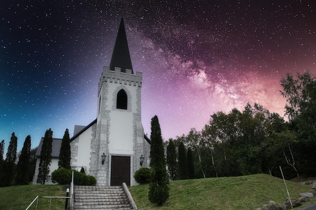 A church with a galaxy in the background