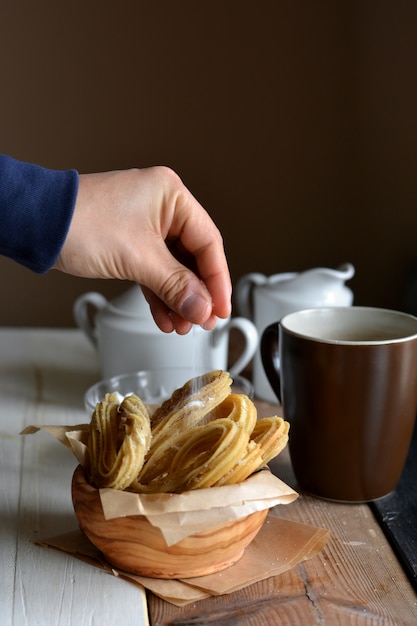 Churros accompanied of a cup of chocolate hot