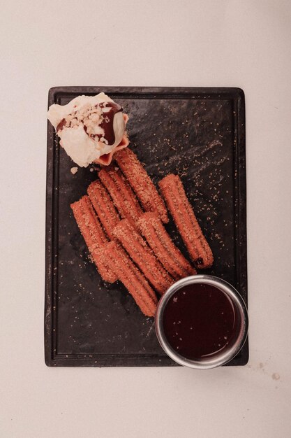 Churros with sugar dipped with chocolate sauce