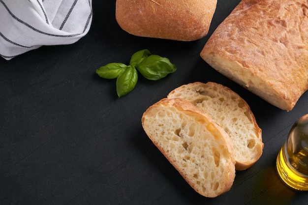 Ciabatta is an Italian white bread made from wheat flour water salt yeast olive oil on black background copy space