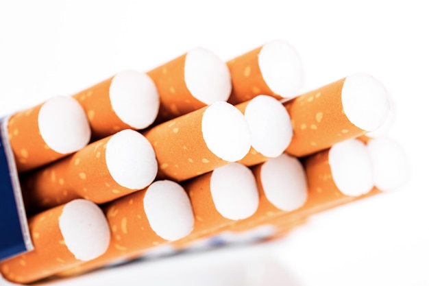 Cigarettes in a pack closeup on white background Smoking tobacco Bad habit