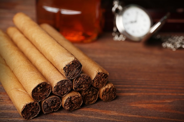 Cigars on wooden table closeup