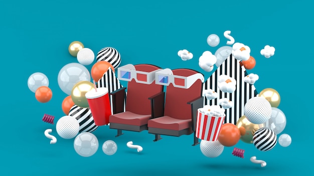 Cinema chair Soft drinks and popcorn among the colorful balls on the blue. 3d rendering.