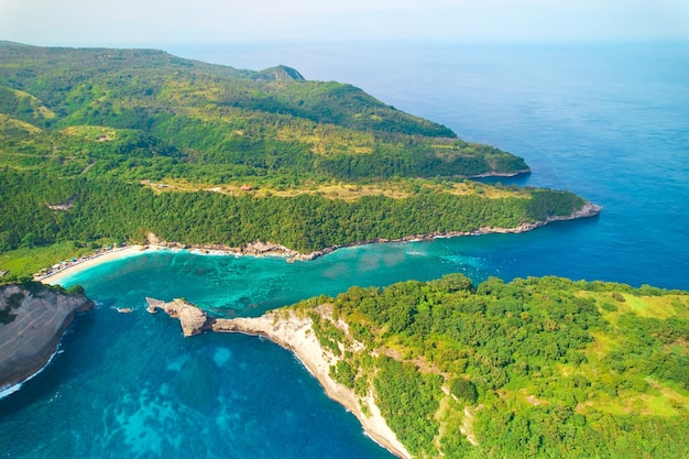 Cinematic aerial landscape shots of the beautiful island Diamond beach of Nusa Penida Huge cliffs by the shoreline and hidden dream beaches with clear water