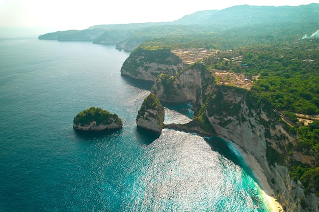 Cinematic aerial landscape shots of the beautiful island Diamond beach of Nusa Penida Huge cliffs by the shoreline and hidden dream beaches with clear water