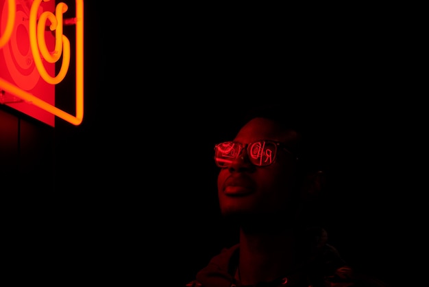 Cinematic portrait of Handsome man with sunglasses  with cool neon lights 