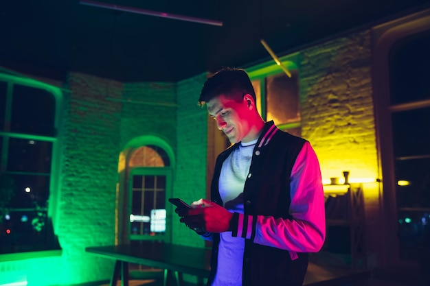 Cinematic portrait of handsome young man using devices