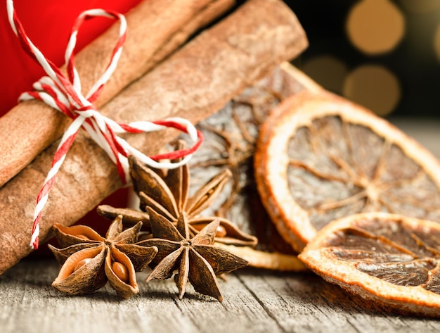 Cinnamon anise and dried oranges on a wooden table closeup