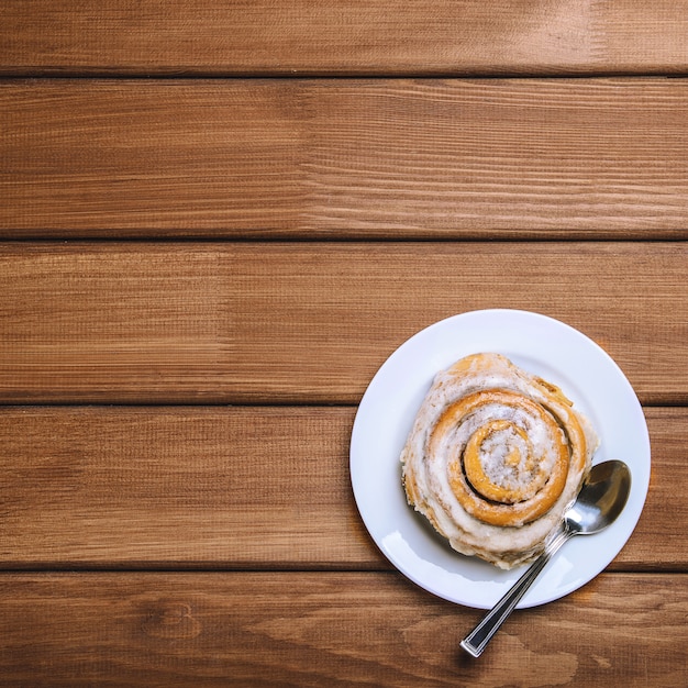 Cinnamon bun on a white plate 