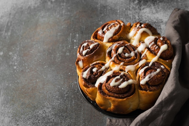 Cinnamon buns or rolls close up on dark background