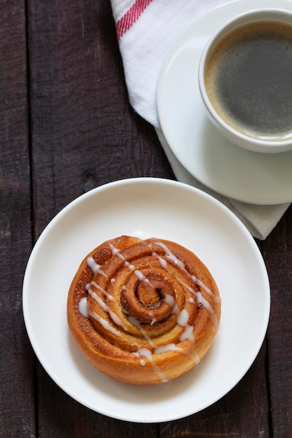 Cinnamon buns with icing served with coffee rustic style