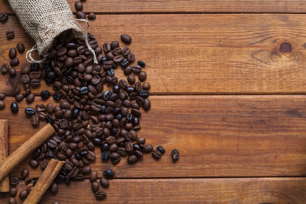 Cinnamon near spilled coffee beans