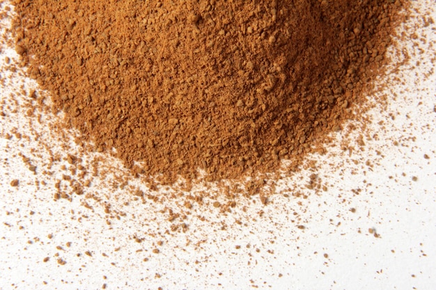 Cinnamon powder heap isolated on white background