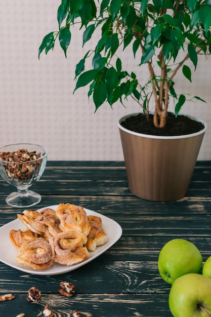 Cinnamon rolls are on a plate Apple crumble on white dish and fresh green apple Easy and Basic dessert menu