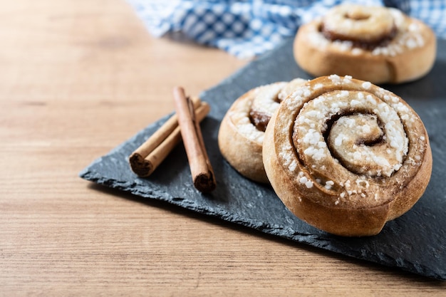 Cinnamon rolls buns on wooden table Kanelbulle Swedish dessert