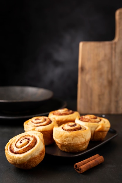 Cinnamon rolls on dark background