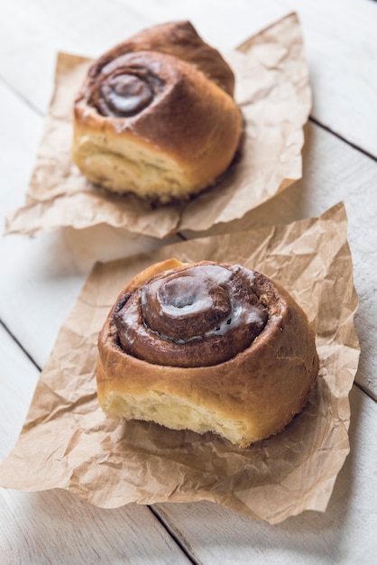 Cinnamon rolls on a white rustic wooden table