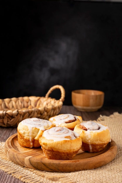 Cinnamon rolls on wooden background