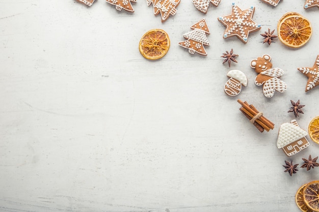 Cinnamon star anise gingerbread and dry orange on white concrete background. Top of view.