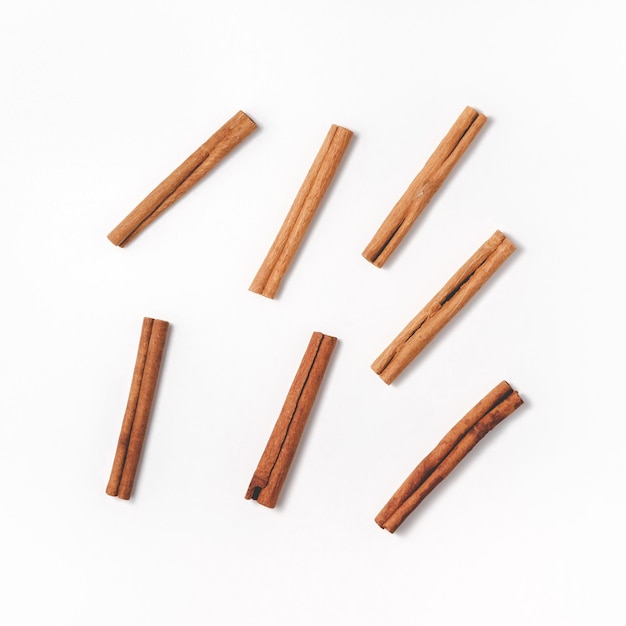 Cinnamon sticks are stacked randomly in the center