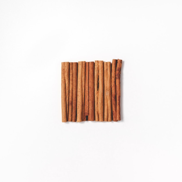 Cinnamon sticks are stacked in a square in the center