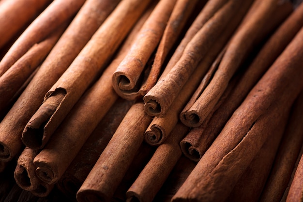 Photo cinnamon sticks background, selective focus.