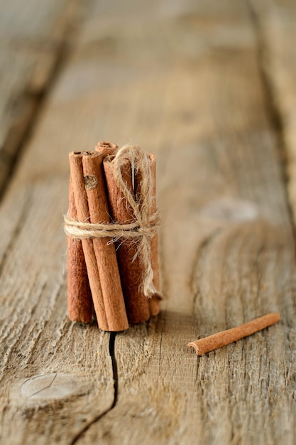 Cinnamon sticks on dark wood table Shallow depth of field