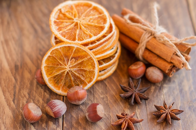 cinnamon sticks, dry oranges and anise on wooden table,  ingredients for mulled wine or baking.