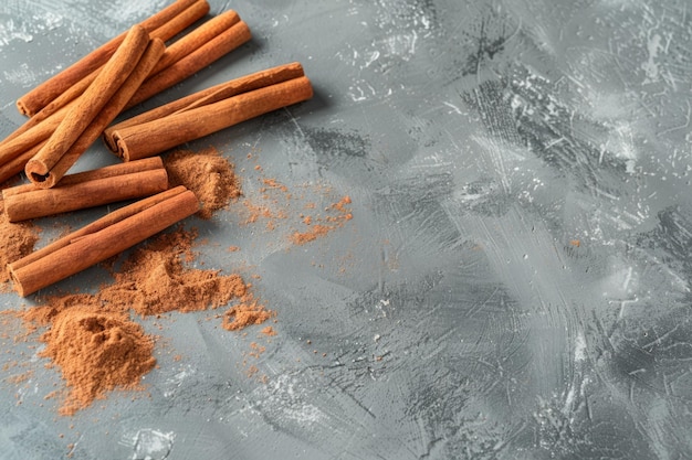 Photo cinnamon sticks lay on a textured gray surface sweet and spicy aroma fills the air perfect for cooking and baking ideal for food photography generative ai