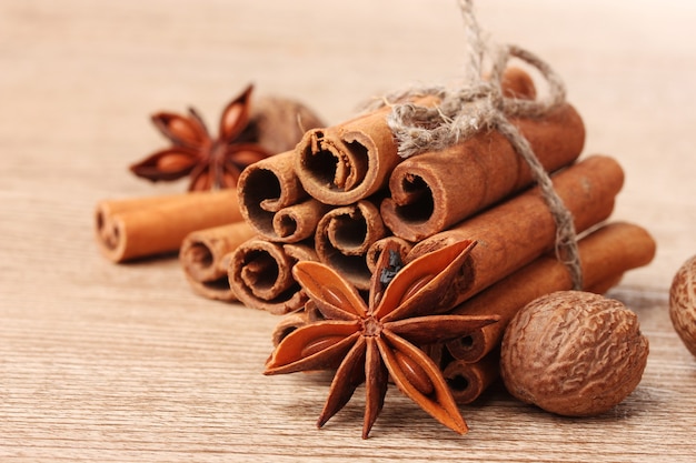 Cinnamon sticks, nutmeg and anise on wooden table