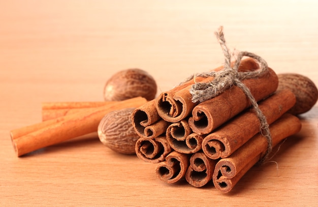 Cinnamon sticks and nutmeg on wooden table