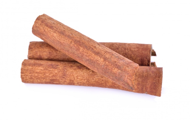 Cinnamon sticks and powder on white background