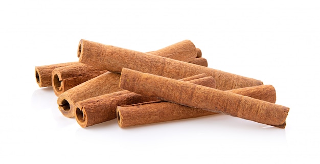 Cinnamon sticks stacked on white