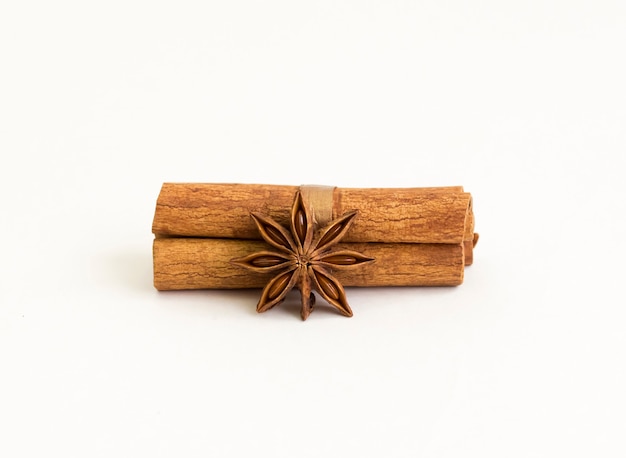 Cinnamon sticks and star anise on a white.