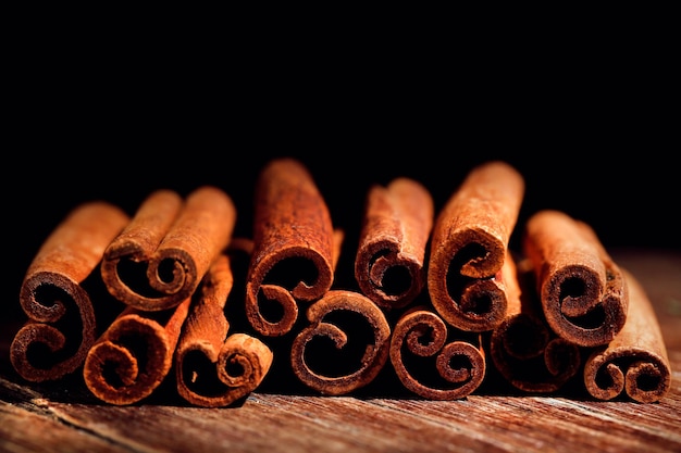 Cinnamon sticks on table on dark background