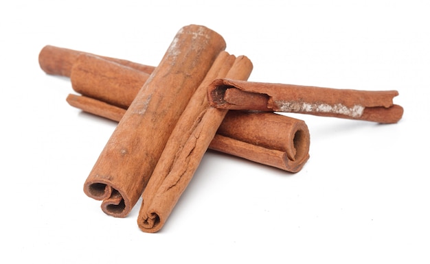 Cinnamon sticks on white surface