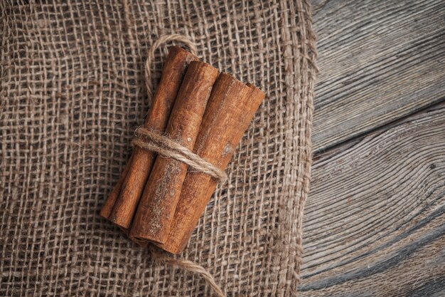 Cinnamon sticks on wooden surface 