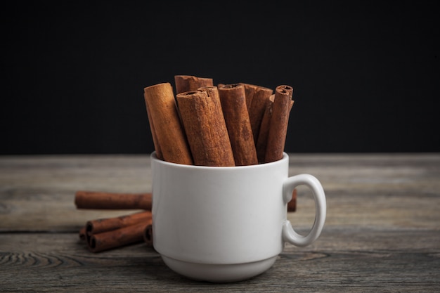 Cinnamon sticks on wooden table.