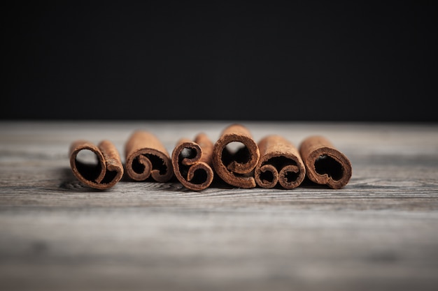 Cinnamon sticks on wooden table.