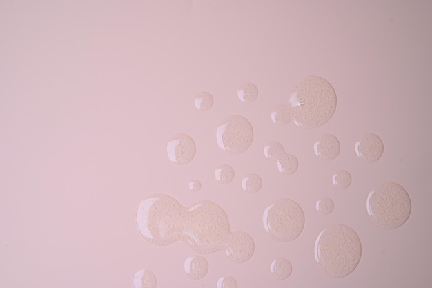 Circle swatch made from skin care gel on pastel pink syrface with copy space Skincare cosmetic product texture