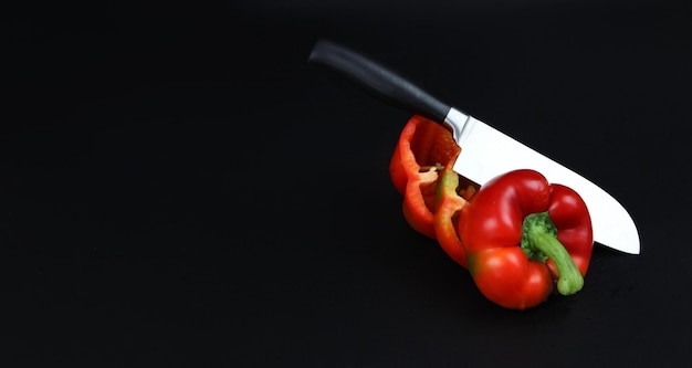 Circles of red pepper with knife Concept for healthy nutrition Top view Copy space