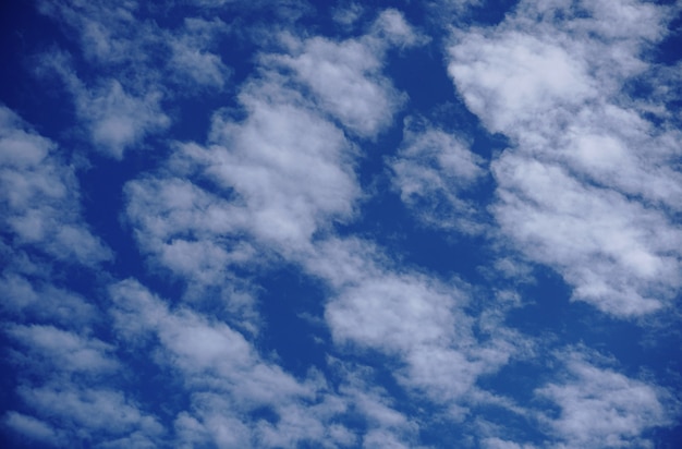 Cirrocumulus and Altocumulus fluffy clouds on light blue sky background.    