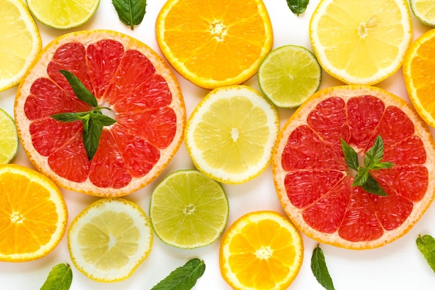 Citrus food pattern on white background assorted citrus fruits with mint leaves