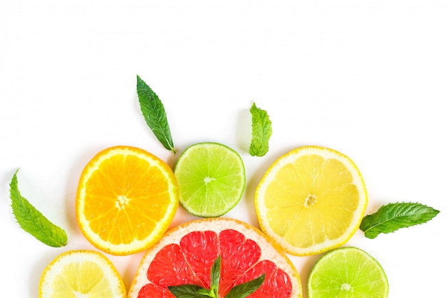 Citrus food pattern on white background - assorted citrus fruits with mint leaves