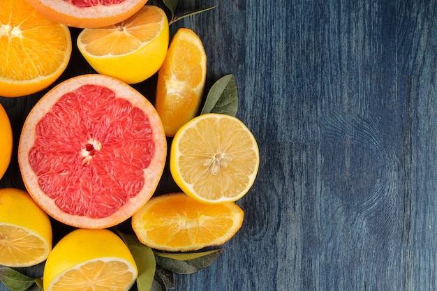 Citrus fruit. Different citrus fruits with leaves of lemon, orange, grapefruit on a blue wooden table. top view