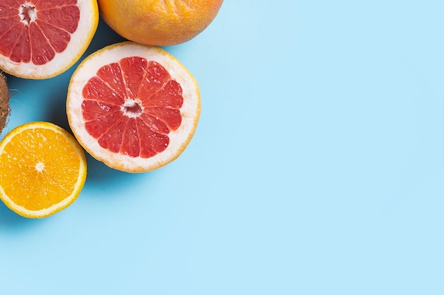 Citrus fruits on a blue background. Orange, grapefruit